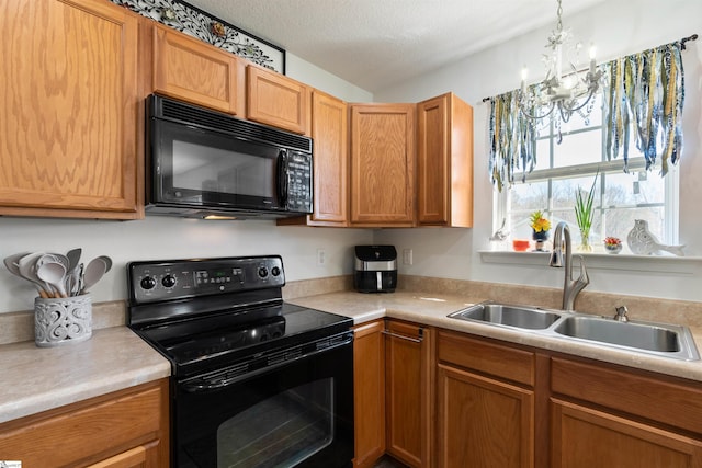 640 Slippery Moss Dr, Spartanburg, SC 29303 - kitchen featuring black appliances, a sink, a chandelier, light countertops, and hanging light fixtures