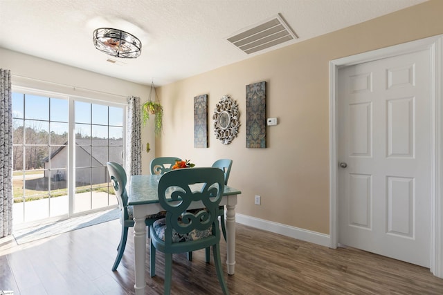640 Slippery Moss Dr, Spartanburg, SC 29303 - dining area with wood finished floors, baseboards, and a textured ceiling