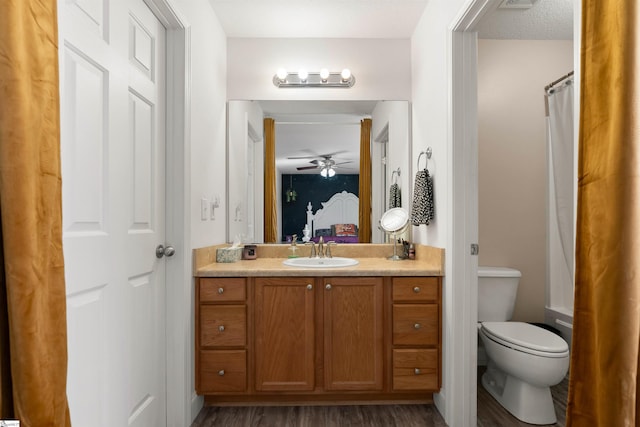 640 Slippery Moss Dr, Spartanburg, SC 29303 - ensuite bathroom with vanity, toilet, wood finished floors, and a ceiling fan