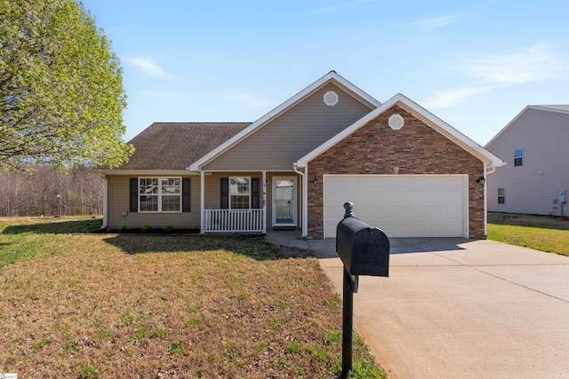 640 Slippery Moss Dr, Spartanburg, SC 29303 - view of front of property with an attached garage, driveway, a front lawn, stone siding, and a porch