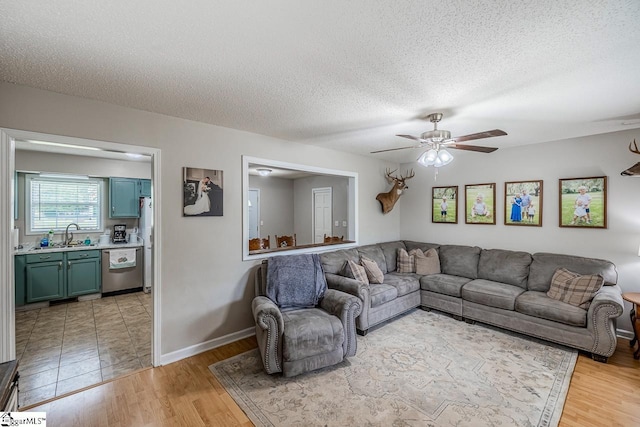 217 Ponder Rd, Greer, SC 29651 - living area with a ceiling fan, light wood-style floors, a textured ceiling, and baseboards