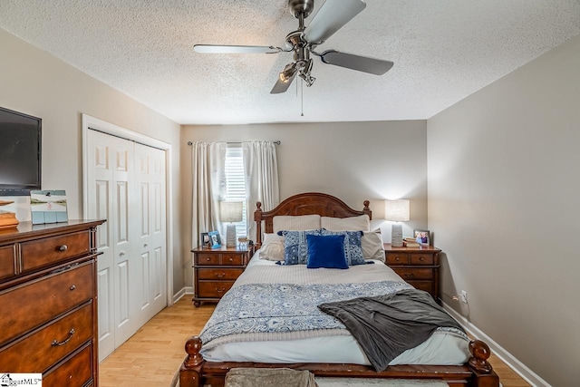 217 Ponder Rd, Greer, SC 29651 - bedroom with a textured ceiling, light wood finished floors, a closet, ceiling fan, and baseboards