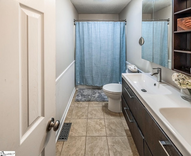 217 Ponder Rd, Greer, SC 29651 - full bath featuring a textured ceiling, toilet, double vanity, a shower with shower curtain, and tile patterned floors