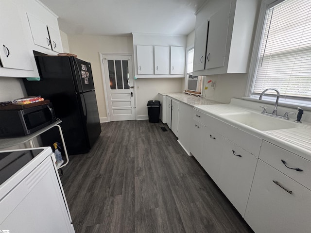 422 E Savannah St, Calhoun Falls, SC 29628 - kitchen featuring stainless steel microwave, dark wood finished floors, range, white cabinetry, and light countertops