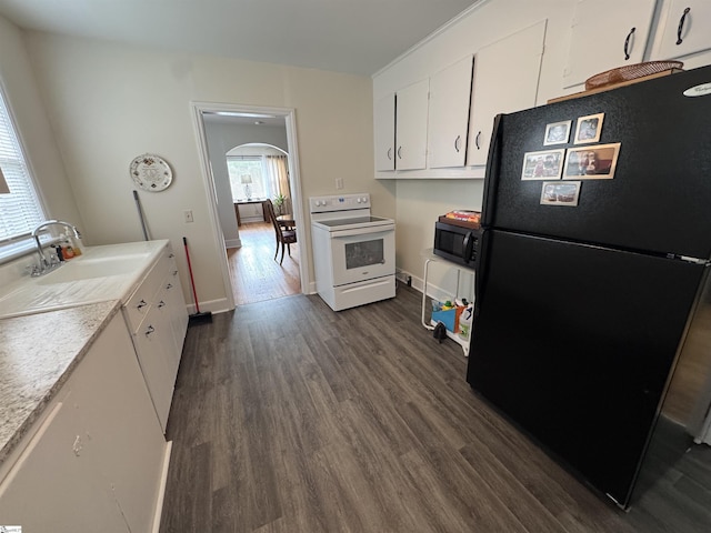 422 E Savannah St, Calhoun Falls, SC 29628 - kitchen with black appliances, arched walkways, dark wood-type flooring, white cabinets, and a sink