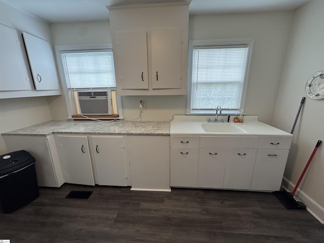 422 E Savannah St, Calhoun Falls, SC 29628 - kitchen with a sink, cooling unit, white cabinets, light countertops, and dark wood-style floors