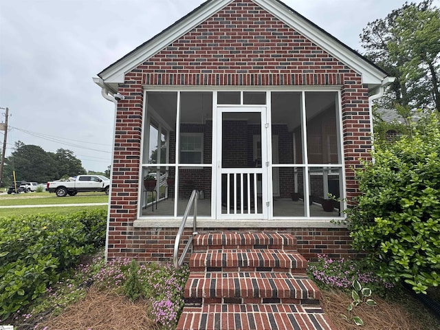 422 E Savannah St, Calhoun Falls, SC 29628 - rear view of property featuring a sunroom and brick siding