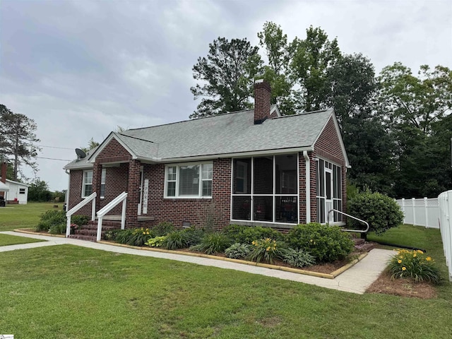422 E Savannah St, Calhoun Falls, SC 29628 - view of front of property featuring brick siding, a chimney, a sunroom, and a shingled roof
