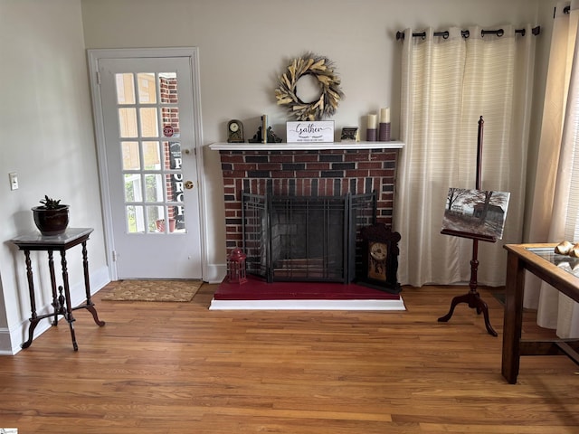 422 E Savannah St, Calhoun Falls, SC 29628 - living area with wood finished floors, a fireplace, and baseboards