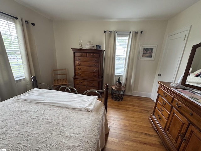 422 E Savannah St, Calhoun Falls, SC 29628 - bedroom with multiple windows, wood finished floors, and baseboards
