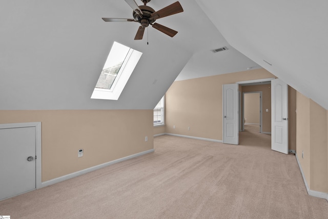 508 Inner Banks Rd, Boiling Springs, SC 29316 - bonus room with light carpet, a ceiling fan, a skylight, vaulted ceiling, and baseboards