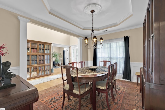 508 Inner Banks Rd, Boiling Springs, SC 29316 - dining space featuring a raised ceiling, wainscoting, a chandelier, crown molding, and wood finished floors
