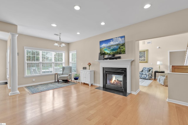 508 Inner Banks Rd, Boiling Springs, SC 29316 - living area featuring ornate columns, light wood-style flooring, a multi sided fireplace, recessed lighting, and baseboards