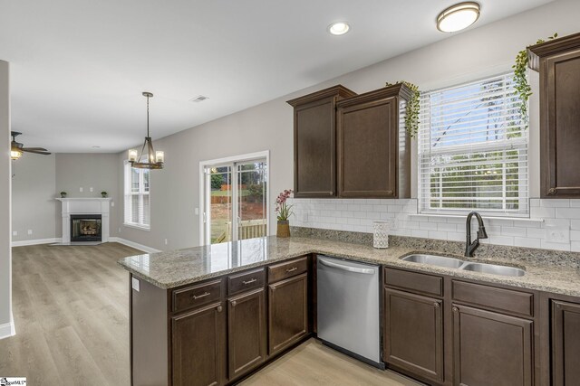 9 Amber Oaks Dr, Greer, SC 29651 - kitchen with dishwasher, a sink, a peninsula, light wood-type flooring, and dark brown cabinetry