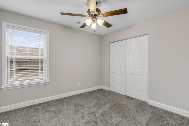 9 Amber Oaks Dr, Greer, SC 29651 - unfurnished bedroom with carpet flooring, a closet, baseboards, and a ceiling fan
