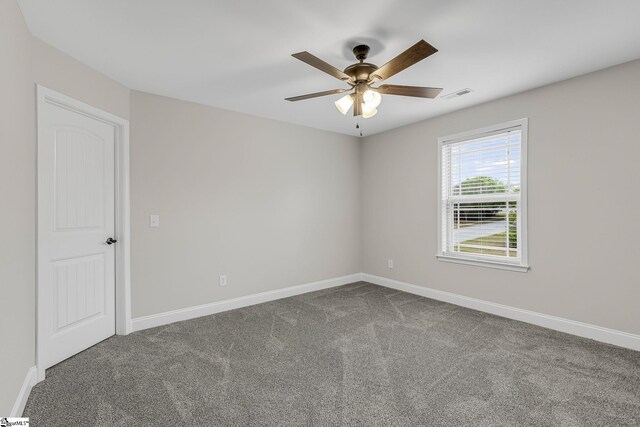 9 Amber Oaks Dr, Greer, SC 29651 - spare room with dark colored carpet, a ceiling fan, and baseboards