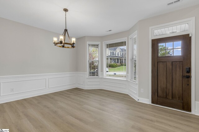 9 Amber Oaks Dr, Greer, SC 29651 - entryway with a chandelier, a wainscoted wall, and light wood-type flooring