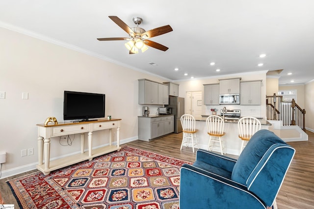 319 Sudduth Farms Dr, Greer, SC 29650 - living area featuring light wood-style flooring, crown molding, baseboards, ceiling fan, and stairs