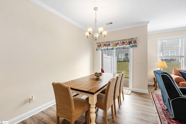 319 Sudduth Farms Dr, Greer, SC 29650 - dining area featuring a chandelier, crown molding, light wood-type flooring, and baseboards