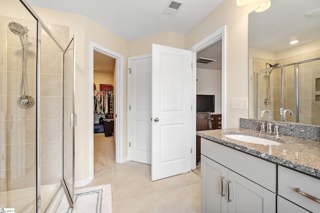 319 Sudduth Farms Dr, Greer, SC 29650 - full bathroom with a shower stall, vanity, tile patterned flooring, and a spacious closet