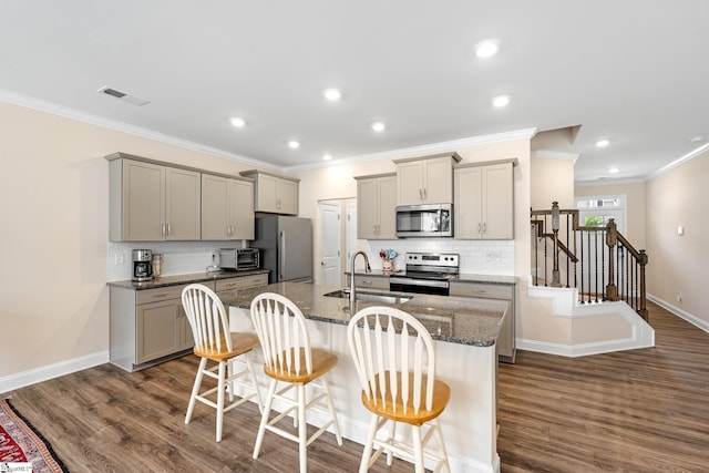 319 Sudduth Farms Dr, Greer, SC 29650 - kitchen with stainless steel appliances, gray cabinets, a sink, ornamental molding, and backsplash