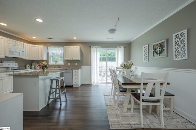 1198 Dalrymple Rd, Anderson, SC 29621 - dining space featuring ornamental molding, a textured ceiling, a wainscoted wall, dark wood-type flooring, and recessed lighting