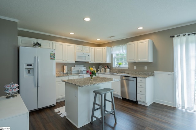 1198 Dalrymple Rd, Anderson, SC 29621 - kitchen with white appliances, a sink, dark wood-style floors, white cabinets, and ornamental molding