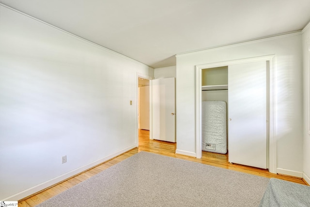 129 E Main St, Duncan, SC 29334 - unfurnished bedroom featuring ornamental molding, light wood-style flooring, baseboards, and a closet