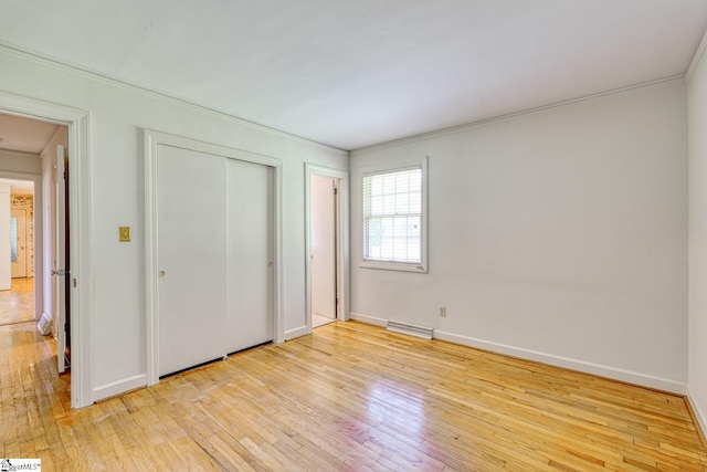 129 E Main St, Duncan, SC 29334 - unfurnished bedroom featuring ornamental molding, light wood-type flooring, baseboards, and a closet