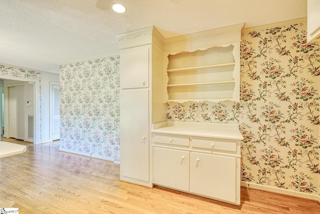 129 E Main St, Duncan, SC 29334 - kitchen featuring wallpapered walls, light wood-type flooring, open shelves, crown molding, and baseboards