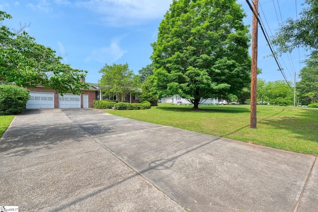 129 E Main St, Duncan, SC 29334 - obstructed view of property featuring a front yard, a garage, brick siding, and concrete driveway