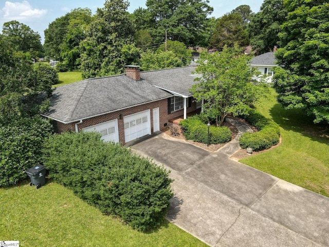 129 E Main St, Duncan, SC 29334 - view of front of house featuring an attached garage, driveway, a front lawn, and brick siding