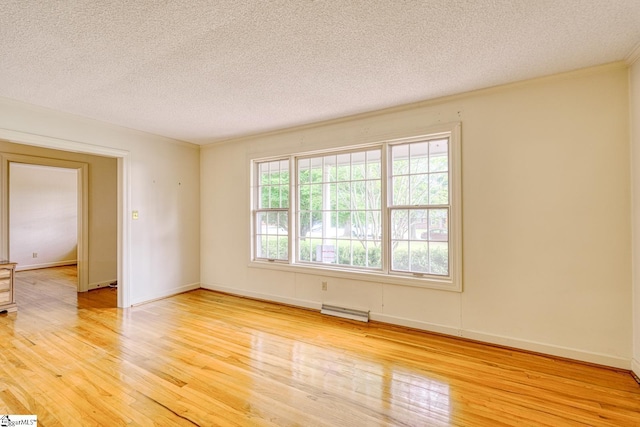 129 E Main St, Duncan, SC 29334 - empty room featuring light wood-style floors, a textured ceiling, baseboards, and crown molding