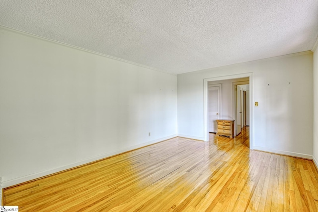 129 E Main St, Duncan, SC 29334 - spare room featuring light wood-style flooring, a textured ceiling, and baseboards