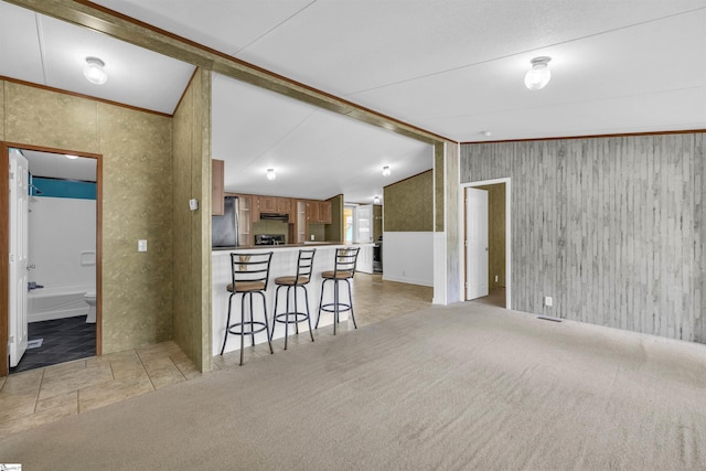 118 Quail Rd, Ninety Six, SC 29666 - kitchen with under cabinet range hood, a breakfast bar area, freestanding refrigerator, open floor plan, and a peninsula