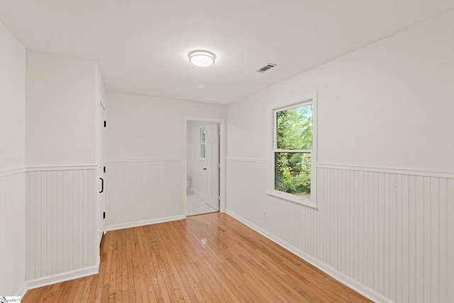 113 Roberts Farm Rd, Simpsonville, SC 29681 - unfurnished room with a wainscoted wall and light wood-type flooring