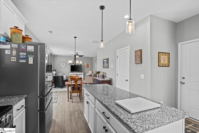 610 Circinae Rd, Cowpens, SC 29330 - kitchen featuring light wood finished floors, white cabinets, a kitchen island, ceiling fan, and appliances with stainless steel finishes