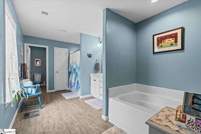 610 Circinae Rd, Cowpens, SC 29330 - full bath featuring wood finished floors, baseboards, a garden tub, a shower with curtain, and vanity