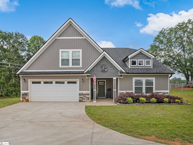 225 Aldrich Rd, Chesnee, SC 29323 - craftsman-style house featuring driveway, stone siding, a front lawn, roof with shingles, and a garage