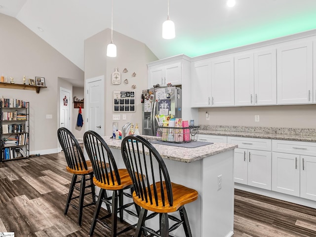 225 Aldrich Rd, Chesnee, SC 29323 - kitchen with stainless steel refrigerator with ice dispenser, lofted ceiling, dark wood-style floors, white cabinets, and a breakfast bar