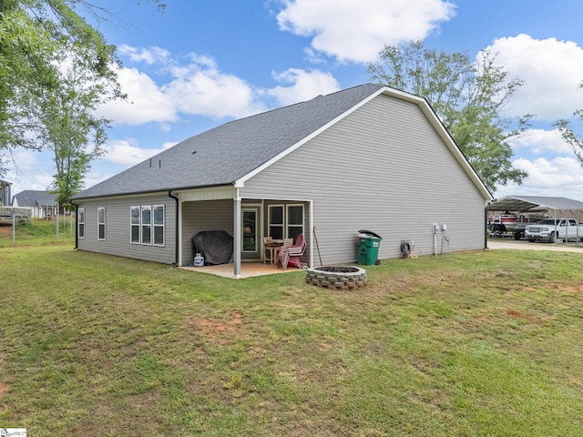 225 Aldrich Rd, Chesnee, SC 29323 - back of house with a detached carport, a fire pit, a lawn, roof with shingles, and a patio