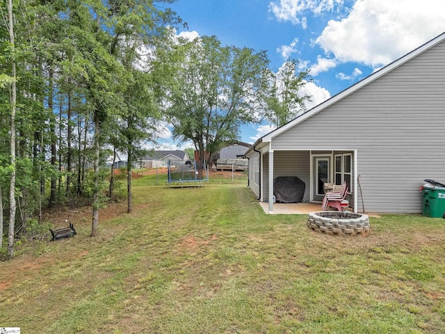 225 Aldrich Rd, Chesnee, SC 29323 - view of grassy yard with a trampoline, a fire pit, and a patio