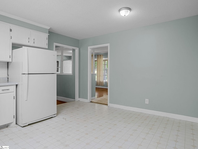 221 N Hill Dr, Boiling Springs, SC 29316 - kitchen featuring freestanding refrigerator, light countertops, white cabinets, a textured ceiling, and light flooring