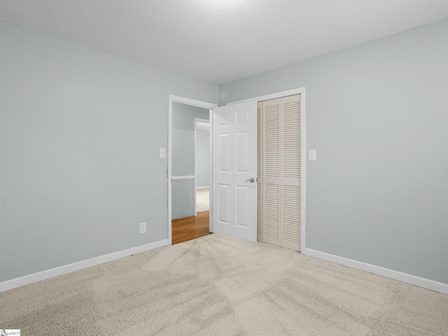 221 N Hill Dr, Boiling Springs, SC 29316 - unfurnished bedroom featuring a closet, carpet, baseboards, and a textured ceiling