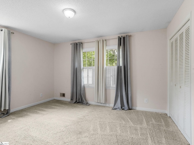 221 N Hill Dr, Boiling Springs, SC 29316 - unfurnished bedroom featuring carpet floors, baseboards, a textured ceiling, and a closet