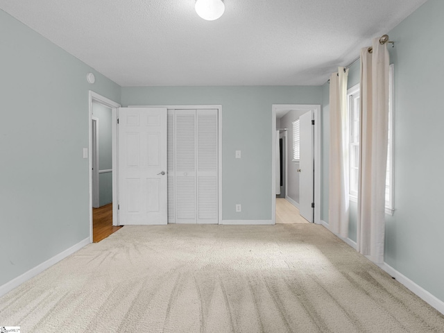 221 N Hill Dr, Boiling Springs, SC 29316 - unfurnished bedroom with carpet, a closet, a textured ceiling, and baseboards