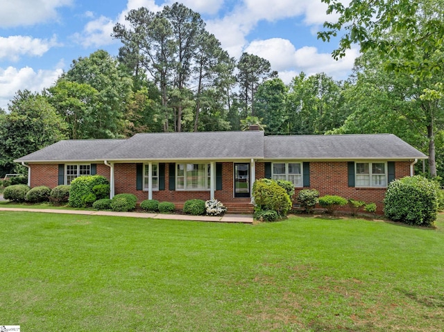 221 N Hill Dr, Boiling Springs, SC 29316 - ranch-style home with brick siding, a front lawn, and view of wooded area