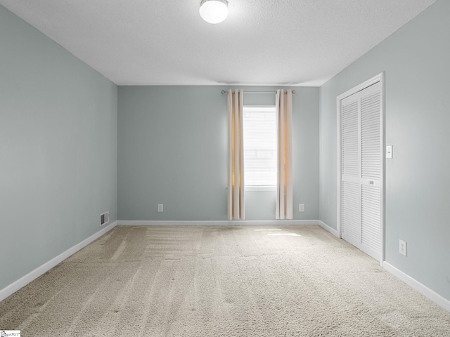 221 N Hill Dr, Boiling Springs, SC 29316 - unfurnished bedroom with carpet floors, a textured ceiling, a closet, and baseboards