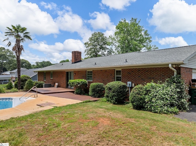221 N Hill Dr, Boiling Springs, SC 29316 - back of property featuring brick siding, a patio, a chimney, a lawn, and an outdoor pool