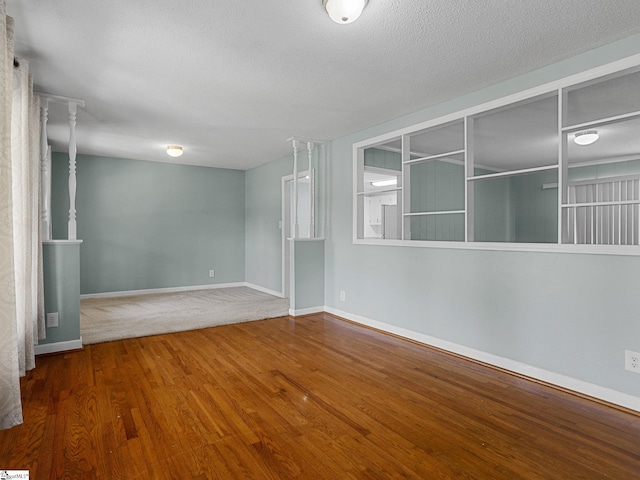 221 N Hill Dr, Boiling Springs, SC 29316 - spare room featuring wood finished floors, baseboards, and a textured ceiling